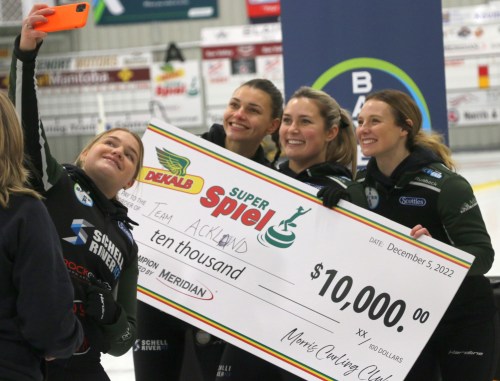 Team Ackland pose for a post-championship selfie with the cheque they earned by winning the Dekald SuperSpiel in Morris Dec. 5. (Cassidy Dankochik The Carillon)
